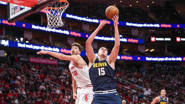 Denver Nuggets center Nikola Jokic grabs a rebound away from Houston Rockets center Alperen Sengun